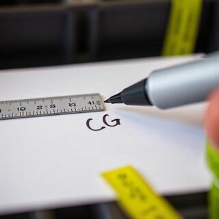 Technician marking centre of gravity on a packed crate