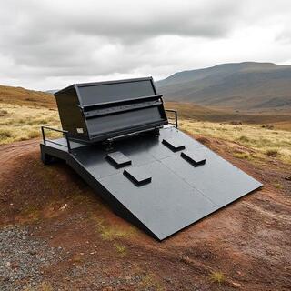 Concert piano being guided down a padded low-angle ramp